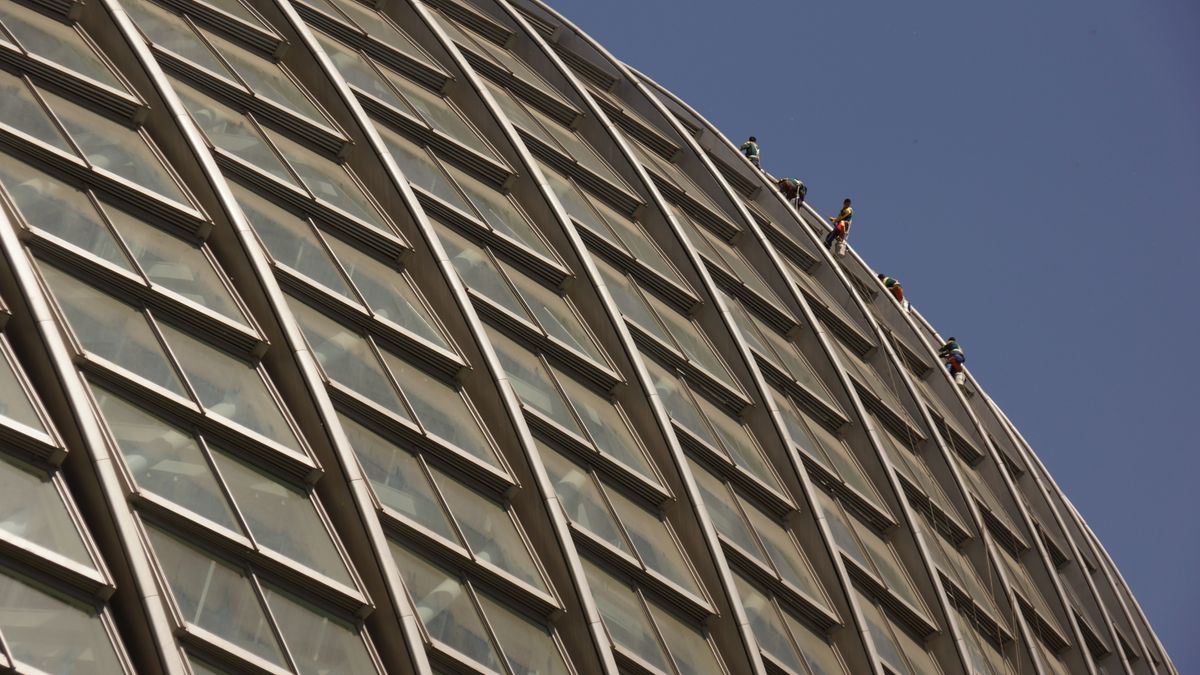 Cleaners absailing down the curved side of this amazing building in Beijing.